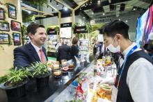 Federal Minister for Trade, Tourism & Investment Simon Birmingham trying vitamin drinks with Ether Dong at the Swisse stand on day one of the China International Import Expo in Shanghai, which was officially opened today by Chinese President Xi Jinping. 